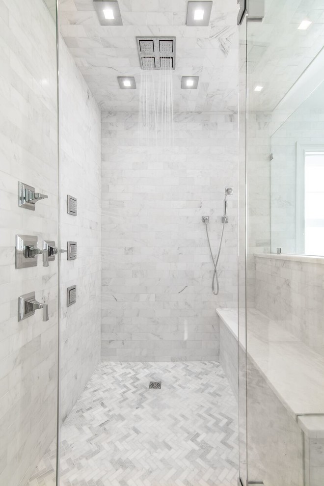 This is an example of a modern ensuite bathroom in New York with white tiles, grey walls, marble flooring and marble worktops.