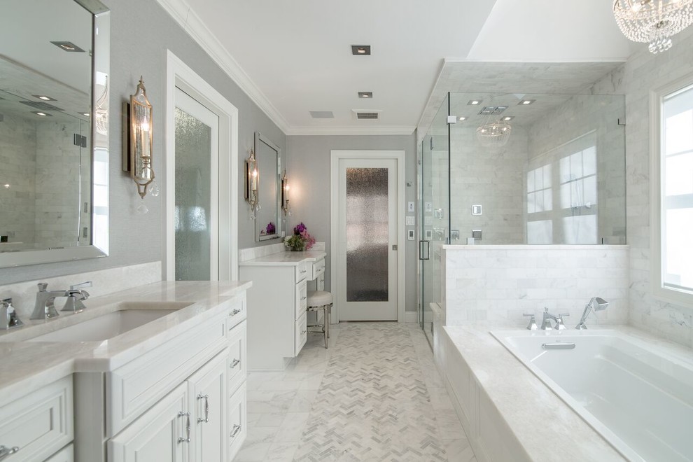 Large contemporary ensuite bathroom in New York with white tiles, grey walls, marble flooring, marble worktops, recessed-panel cabinets, white cabinets, a built-in bath, a corner shower, metro tiles, a submerged sink, grey floors and a hinged door.