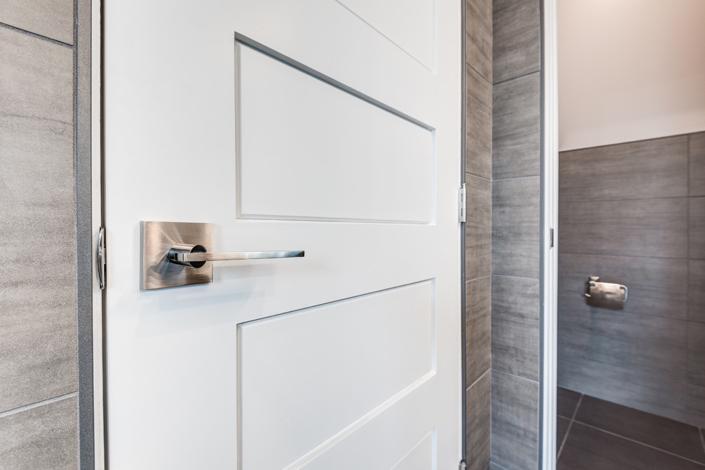 Bathroom - large modern master gray tile and ceramic tile ceramic tile and gray floor bathroom idea in Chicago with raised-panel cabinets, white cabinets, a wall-mount toilet, gray walls, an undermount sink, quartzite countertops and a hinged shower door
