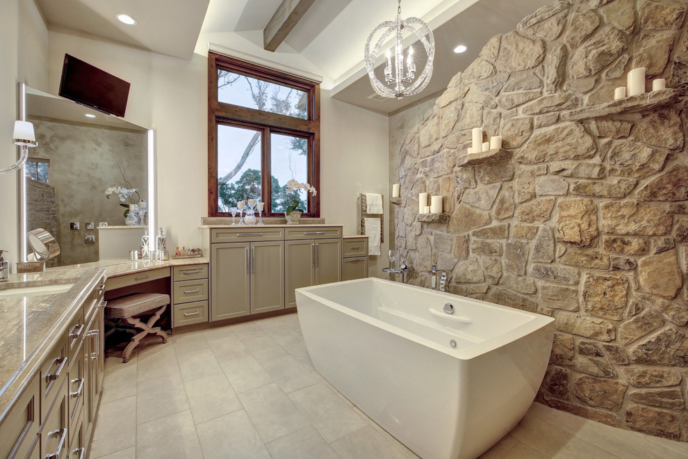На фото: главная ванная комната в стиле кантри с фасадами с утопленной филенкой, бежевыми фасадами, отдельно стоящей ванной, белыми стенами, врезной раковиной и бежевым полом