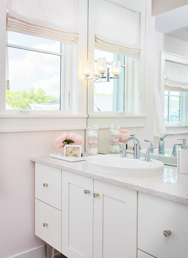 Diseño de cuarto de baño infantil de estilo de casa de campo grande con armarios con paneles lisos, puertas de armario blancas, paredes rosas y encimera de cuarzo compacto