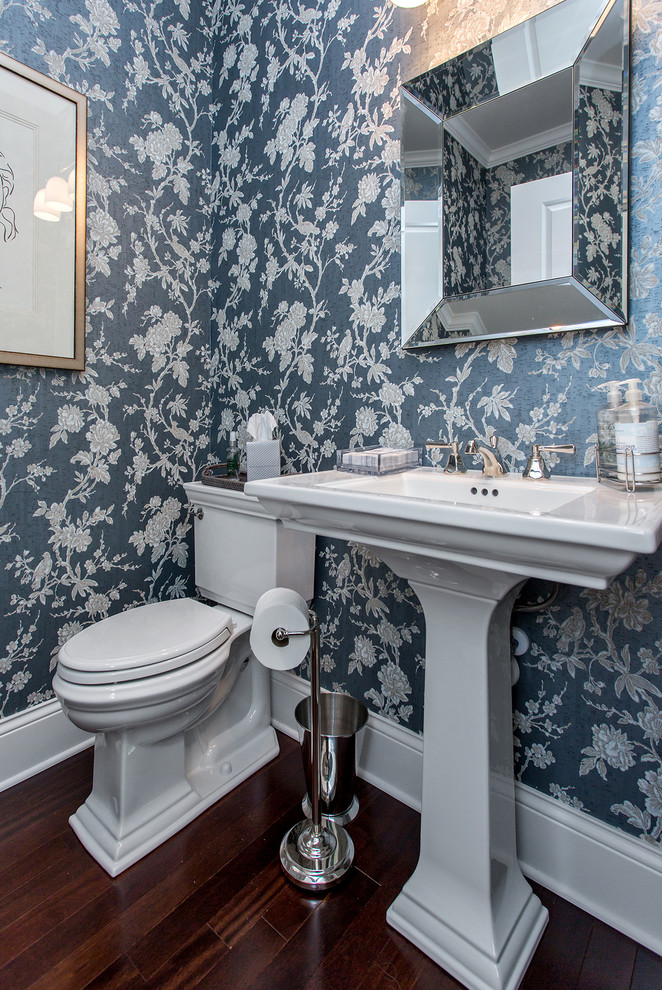 Bathroom - small country blue tile medium tone wood floor and brown floor bathroom idea in Cedar Rapids with white cabinets, a one-piece toilet, blue walls, a pedestal sink, solid surface countertops and white countertops