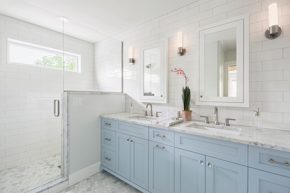 Medium sized traditional ensuite bathroom in Minneapolis with shaker cabinets, an alcove shower, white tiles, white walls, marble flooring, a submerged sink, engineered stone worktops, grey floors, a hinged door, grey worktops, blue cabinets and metro tiles.