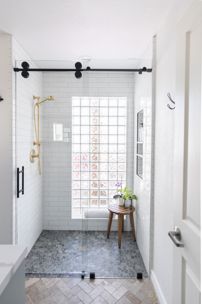 Bild på ett mellanstort lantligt vit vitt badrum med dusch, med vit kakel, tunnelbanekakel, klinkergolv i småsten, grått golv, skåp i shakerstil, turkosa skåp, ett undermonterad handfat, bänkskiva i kvarts och dusch med skjutdörr