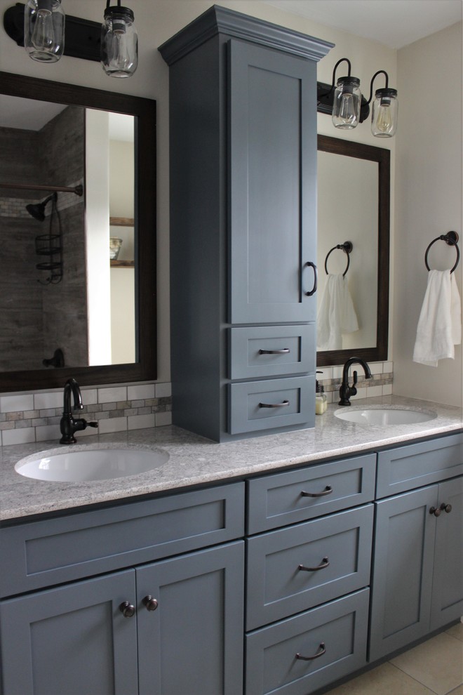 Photo of a small rural bathroom in Philadelphia with shaker cabinets, grey cabinets, an alcove bath, a two-piece toilet, beige tiles, porcelain tiles, beige walls, porcelain flooring, a submerged sink and engineered stone worktops.