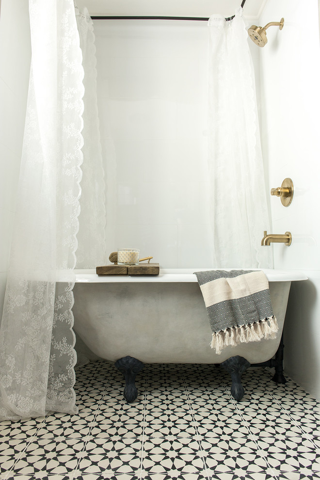 Claw-foot bathtub - small farmhouse master claw-foot bathtub idea in Tampa with furniture-like cabinets, light wood cabinets and a vessel sink