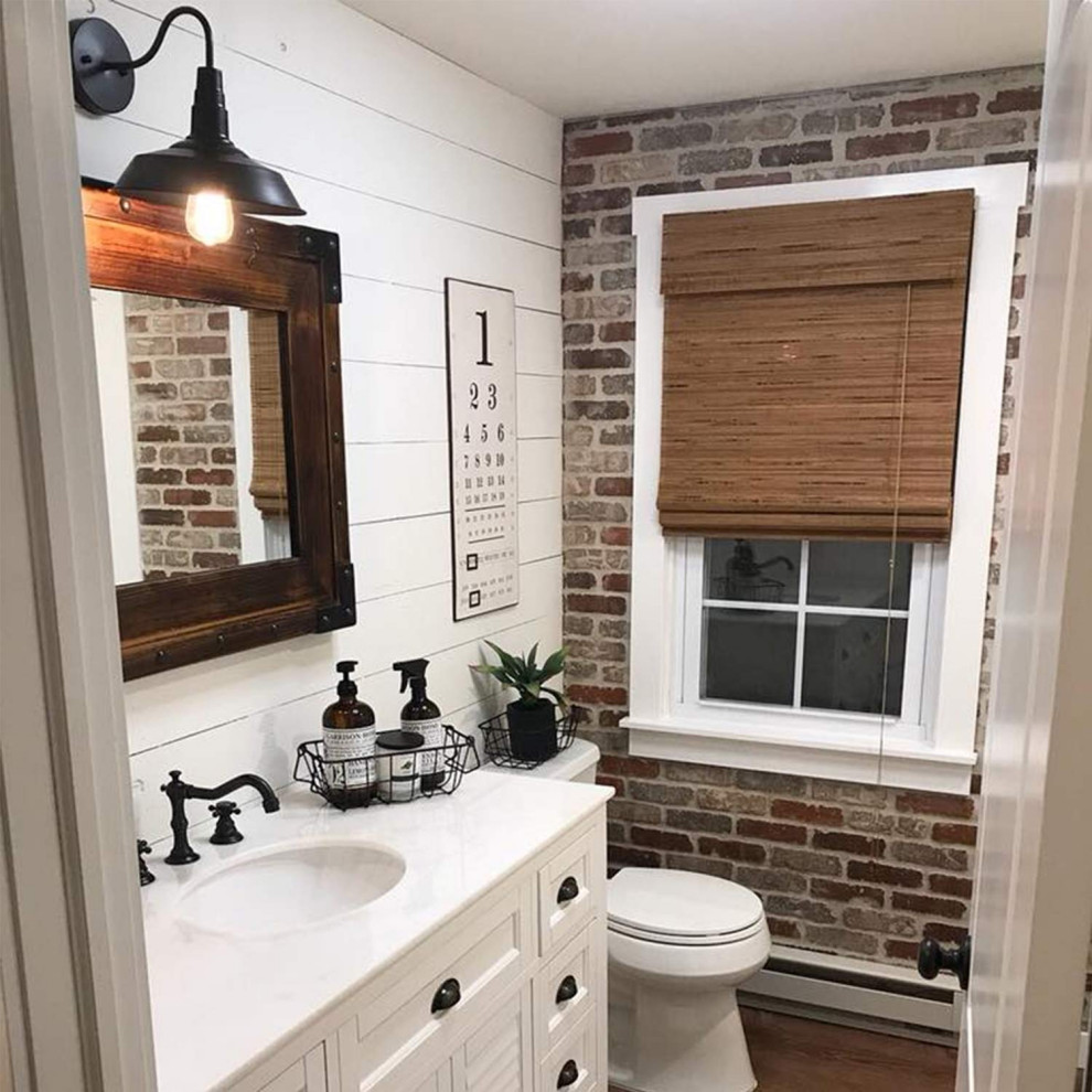 Example of a small trendy 3/4 white tile and ceramic tile plywood floor and brown floor bathroom design in Atlanta with recessed-panel cabinets, white cabinets, a two-piece toilet, white walls, an integrated sink, concrete countertops and brown countertops