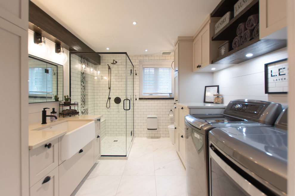 Example of a large cottage 3/4 white tile and subway tile ceramic tile and white floor bathroom design in Ottawa with shaker cabinets, beige cabinets, a one-piece toilet, white walls, a drop-in sink, quartzite countertops, a hinged shower door and beige countertops