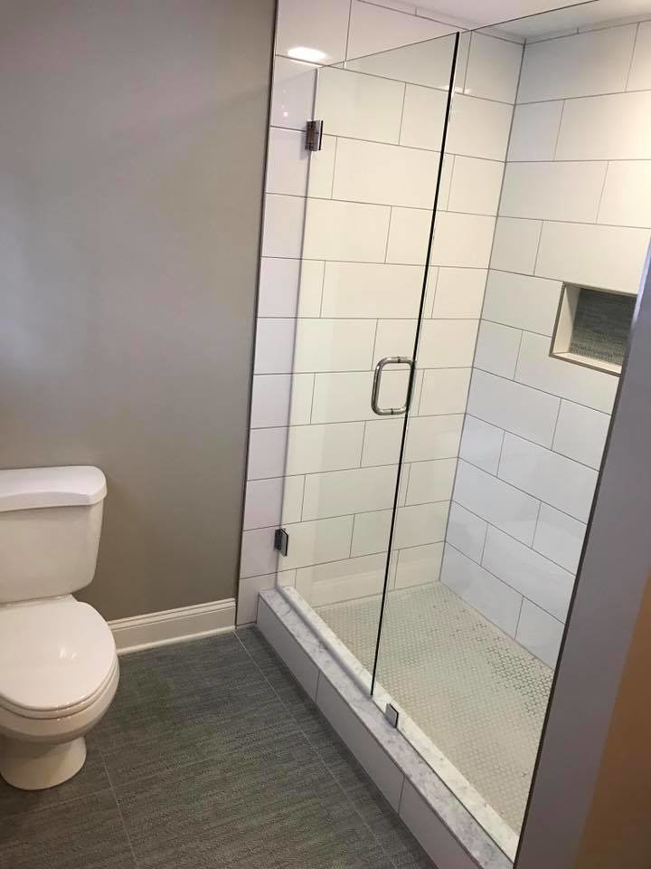 Medium sized country shower room bathroom in Cleveland with raised-panel cabinets, white cabinets, an alcove shower, white tiles, porcelain tiles, a submerged sink, quartz worktops, beige walls, vinyl flooring, grey floors and a hinged door.