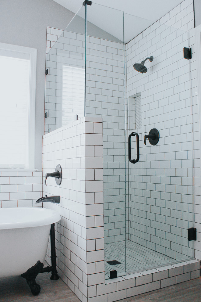 This is an example of a small country ensuite bathroom in Atlanta with a claw-foot bath, a corner shower, a one-piece toilet, white tiles, ceramic tiles, grey walls, porcelain flooring, a vessel sink, grey floors and a hinged door.