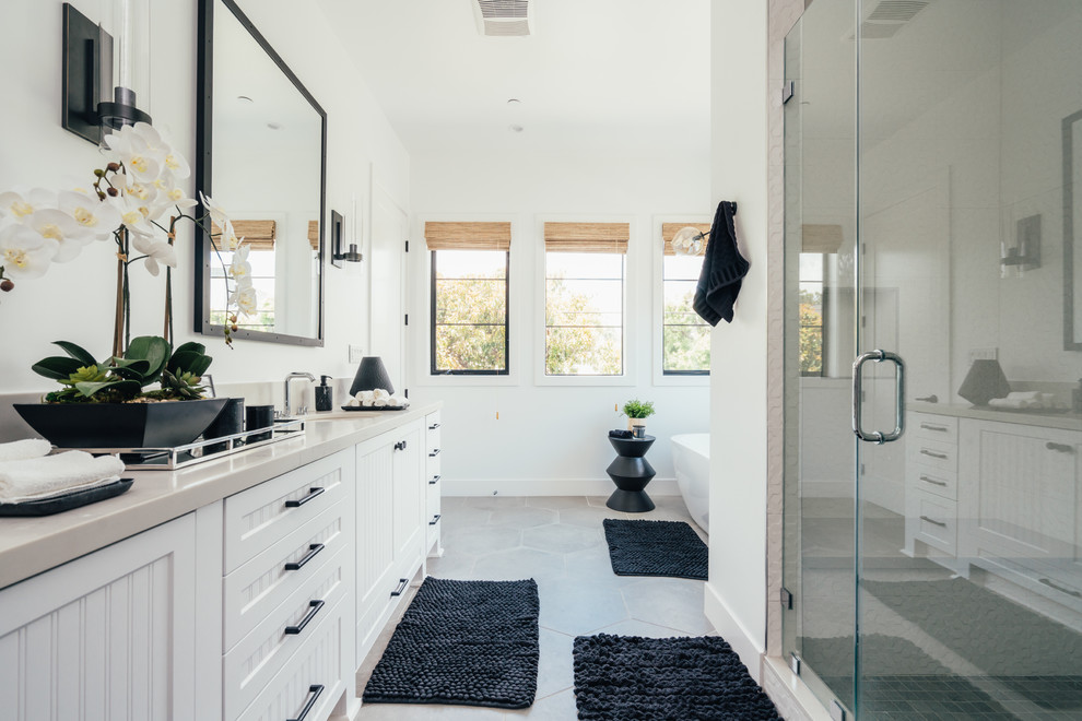 Large country master ceramic tile and gray floor bathroom photo in Los Angeles with shaker cabinets, a bidet, white walls, an undermount sink, quartz countertops, a hinged shower door, white cabinets and gray countertops