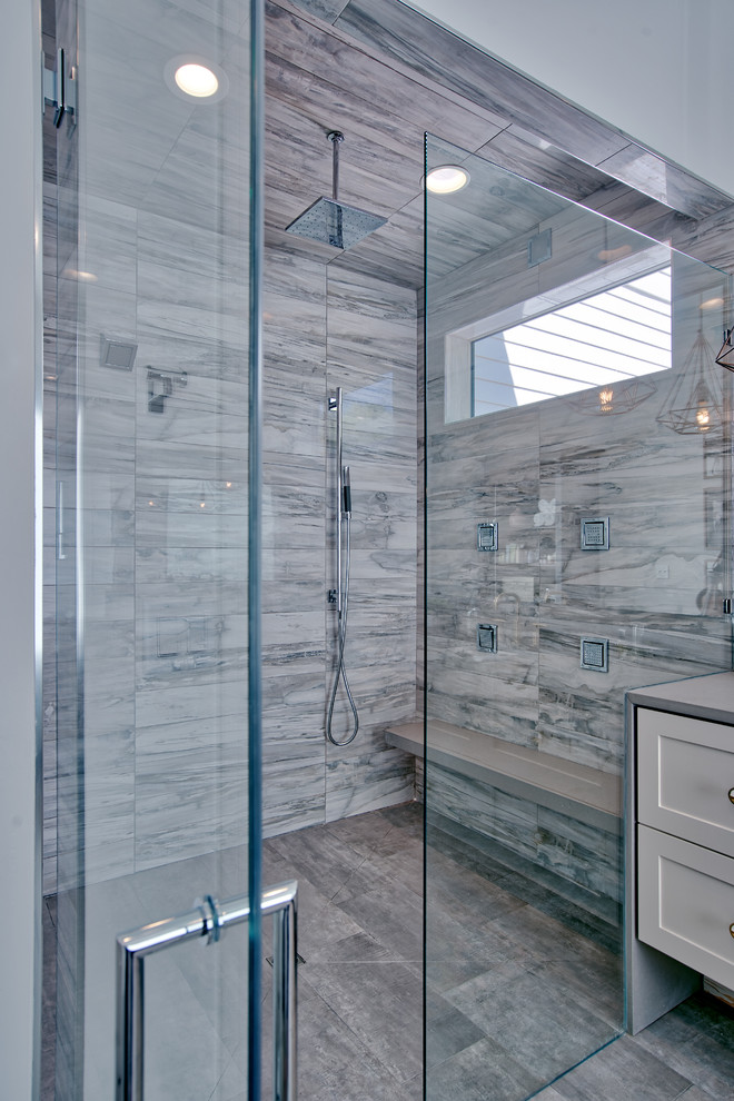 Large modern ensuite bathroom in Atlanta with shaker cabinets, grey cabinets, a freestanding bath, a built-in shower, a one-piece toilet, white tiles, porcelain tiles, white walls, porcelain flooring, a submerged sink, engineered stone worktops, grey floors, a hinged door and grey worktops.