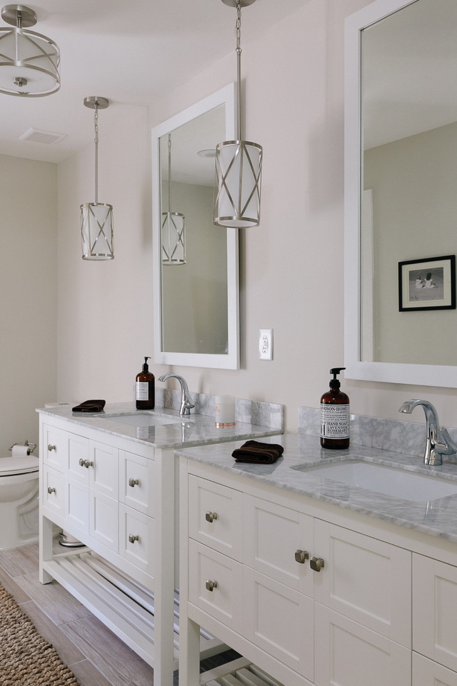 Inspiration for a large classic ensuite bathroom in Atlanta with shaker cabinets, white cabinets, a freestanding bath, a corner shower, a two-piece toilet, grey tiles, ceramic tiles, beige walls, ceramic flooring, a submerged sink and marble worktops.