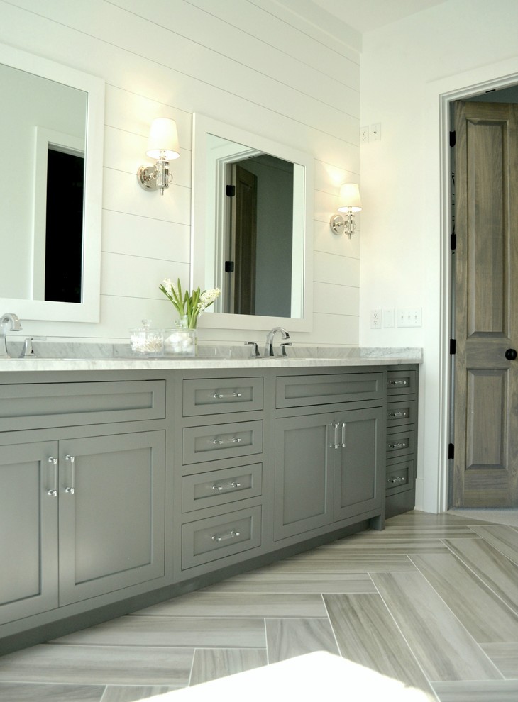 Design ideas for a large farmhouse ensuite bathroom in Indianapolis with a submerged sink, recessed-panel cabinets, grey cabinets, marble worktops, a freestanding bath, a walk-in shower, white tiles, ceramic tiles, white walls and ceramic flooring.
