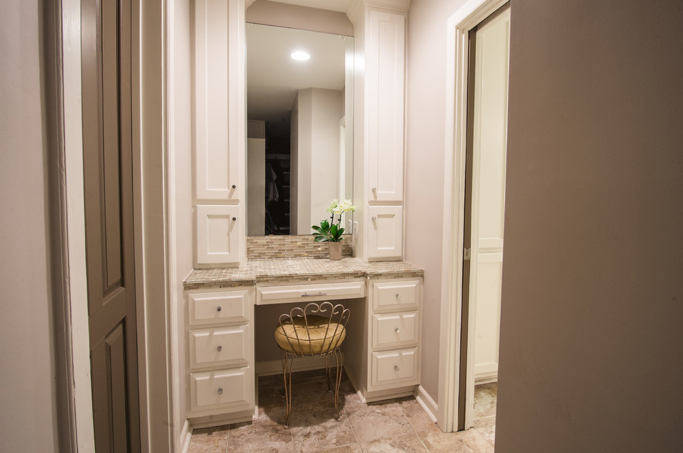 Photo of a medium sized farmhouse ensuite bathroom in New Orleans with a vessel sink, recessed-panel cabinets, white cabinets, glass worktops, a built-in bath, a corner shower, a one-piece toilet, multi-coloured tiles, mosaic tiles, beige walls and ceramic flooring.