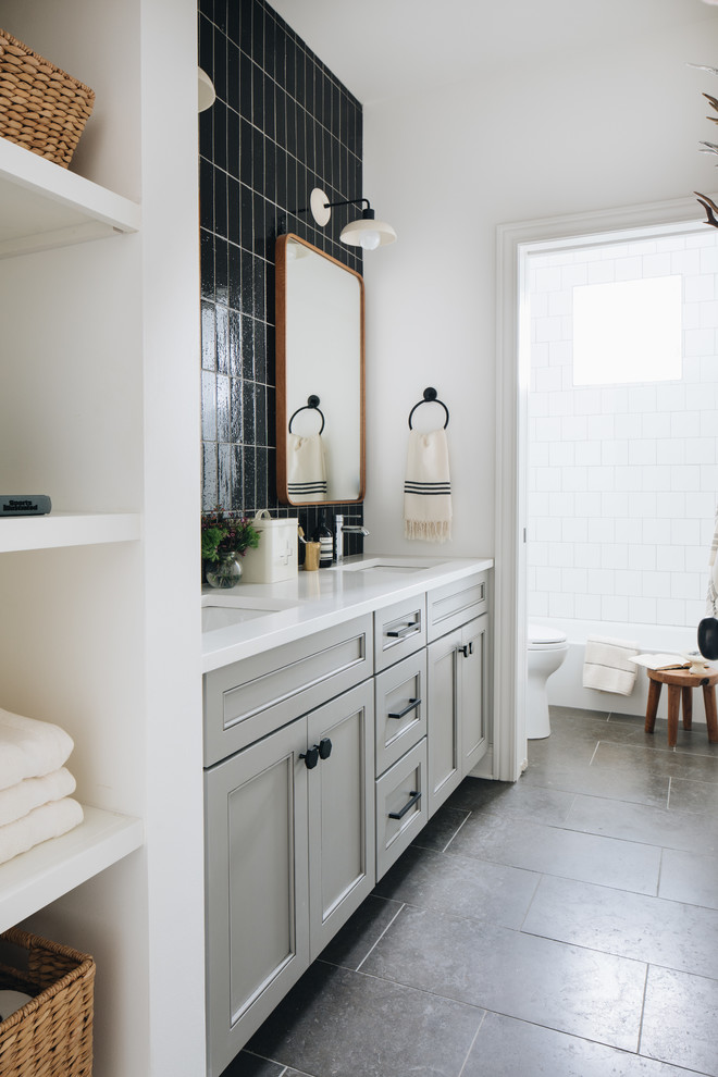 Bathroom - mid-sized transitional 3/4 black tile and terra-cotta tile gray floor, limestone floor and double-sink bathroom idea in Chicago with gray cabinets, white walls, an undermount sink, white countertops, shaker cabinets, a two-piece toilet, quartz countertops and a built-in vanity
