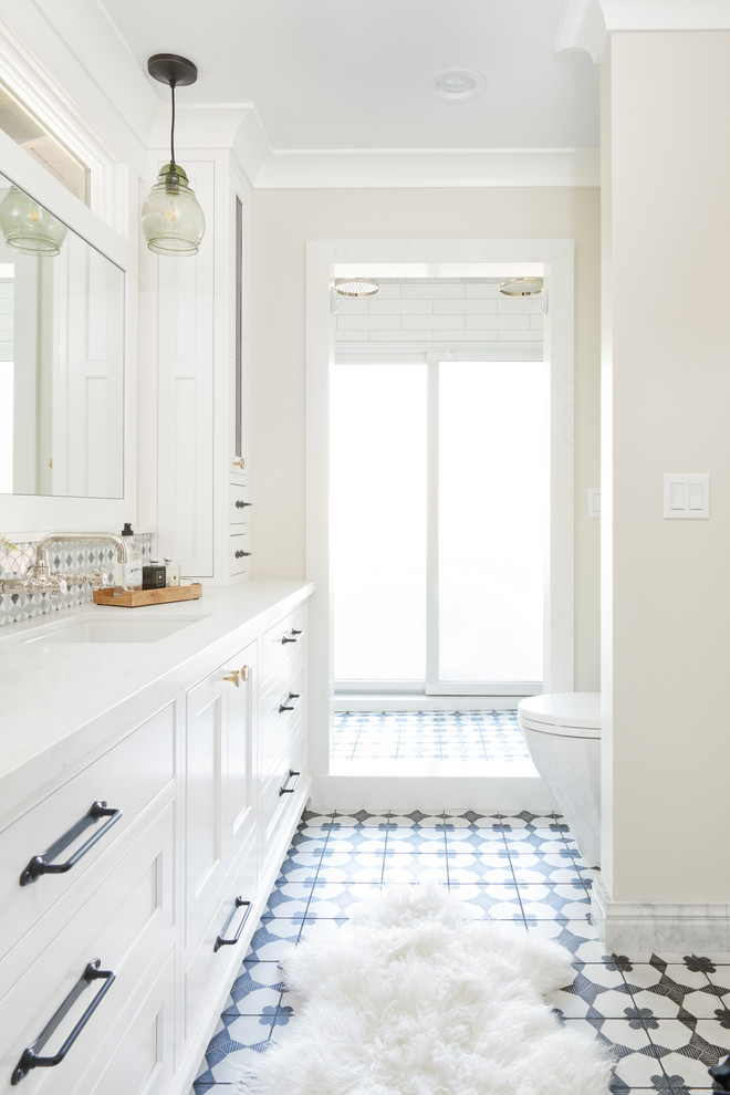Mid-sized country master white tile and mosaic tile ceramic tile and black floor bathroom photo in San Francisco with beaded inset cabinets, white cabinets, quartz countertops, white countertops, a one-piece toilet, beige walls and an undermount sink