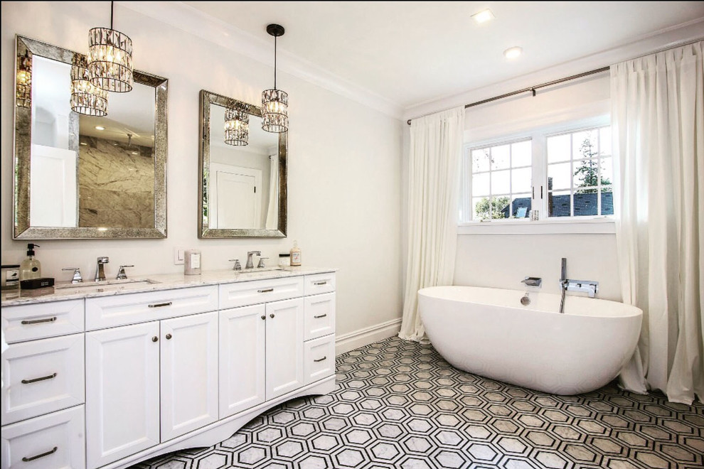 Photo of an expansive country ensuite bathroom in Miami with recessed-panel cabinets, white cabinets, a freestanding bath, a walk-in shower, a two-piece toilet, grey tiles, marble tiles, multi-coloured walls, mosaic tile flooring, a submerged sink, quartz worktops, black floors, an open shower and white worktops.