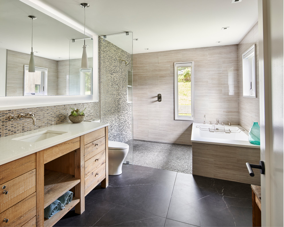 Bathroom - country gray tile black floor and single-sink bathroom idea in Philadelphia with flat-panel cabinets, medium tone wood cabinets, an undermount sink, white countertops, a niche and a freestanding vanity