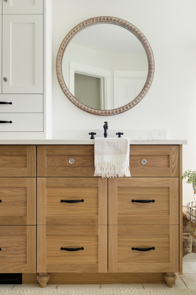 Large modern ensuite bathroom in Minneapolis with beaded cabinets, light wood cabinets, a freestanding bath, a walk-in shower, a one-piece toilet, beige walls, painted wood flooring, a built-in sink, white floors, an open shower and white worktops.