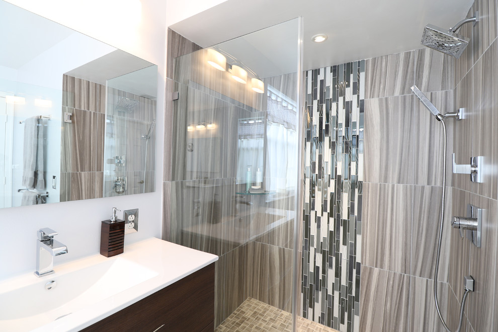 Inspiration for a large modern ensuite bathroom in Miami with an integrated sink, freestanding cabinets, dark wood cabinets, soapstone worktops, a freestanding bath, an alcove shower, a two-piece toilet, grey tiles, porcelain tiles, grey walls and porcelain flooring.