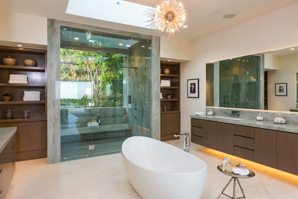Large contemporary ensuite bathroom in Los Angeles with flat-panel cabinets, dark wood cabinets, a freestanding bath, a double shower, grey tiles, stone slabs, white walls, porcelain flooring, a submerged sink and marble worktops.