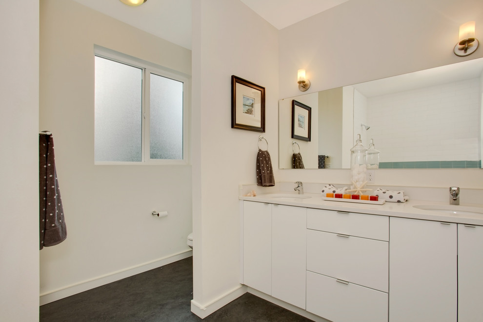 Contemporary bathroom in Seattle with flat-panel cabinets and white cabinets.
