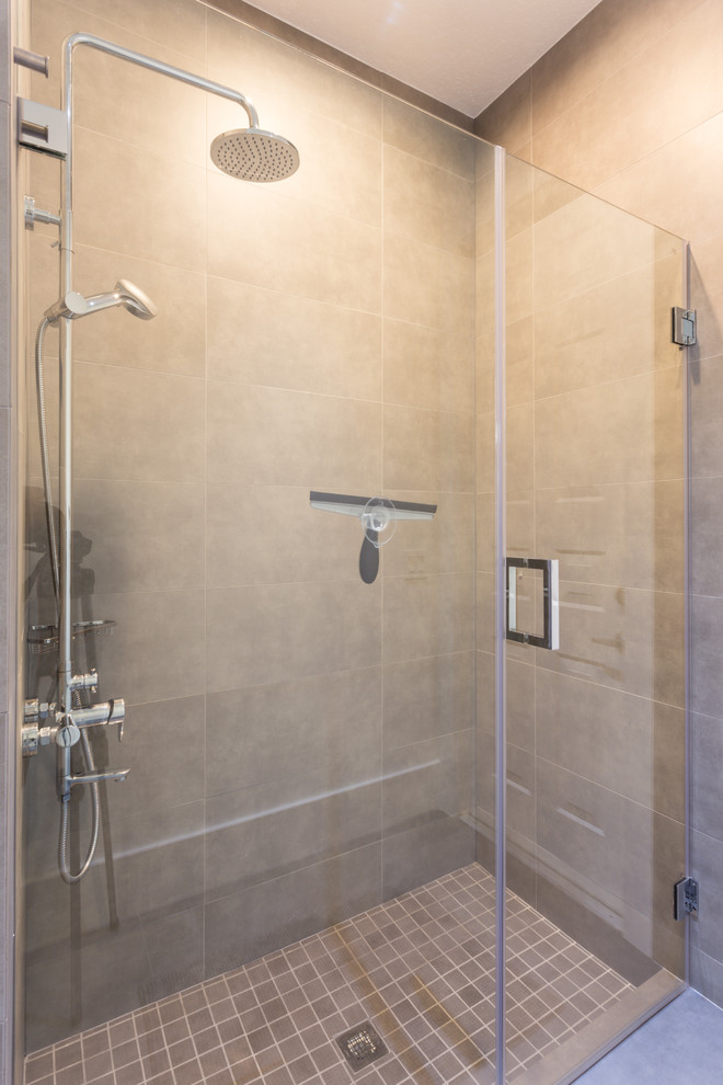 Alcove shower - mid-sized modern kids' gray tile and porcelain tile porcelain tile alcove shower idea in Miami with a vessel sink, flat-panel cabinets, white cabinets, quartz countertops, a one-piece toilet and gray walls
