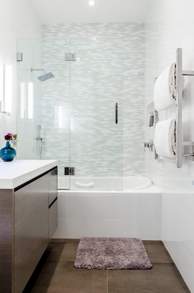 Bathroom - mid-sized modern 3/4 white tile and porcelain tile porcelain tile and gray floor bathroom idea in New York with flat-panel cabinets, brown cabinets, a wall-mount toilet, white walls, an integrated sink, solid surface countertops and a hinged shower door