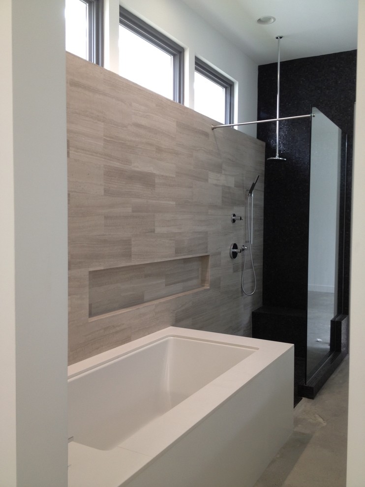 Large minimalist master gray tile and porcelain tile concrete floor and gray floor bathroom photo in New Orleans with flat-panel cabinets, white cabinets, an undermount tub, white walls, an undermount sink, quartz countertops and white countertops