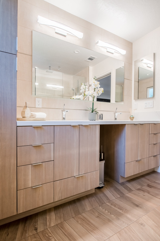 Example of a mid-sized minimalist master beige tile and ceramic tile medium tone wood floor and brown floor walk-in shower design in San Francisco with flat-panel cabinets, light wood cabinets, a bidet, beige walls, an undermount sink, granite countertops and white countertops