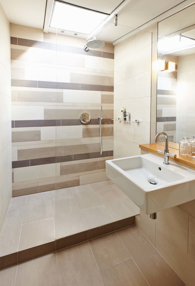 Design ideas for a medium sized contemporary ensuite bathroom in Cambridgeshire with a wall-mounted sink, beige tiles, porcelain tiles, beige walls, a wall mounted toilet, a walk-in shower and an open shower.