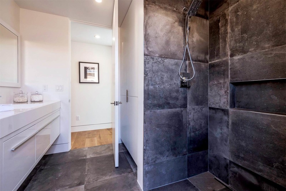 Foto på ett mellanstort funkis en-suite badrum, med släta luckor, vita skåp, våtrum, en toalettstol med hel cisternkåpa, vita väggar, betonggolv, ett integrerad handfat, bänkskiva i akrylsten, grått golv och med dusch som är öppen