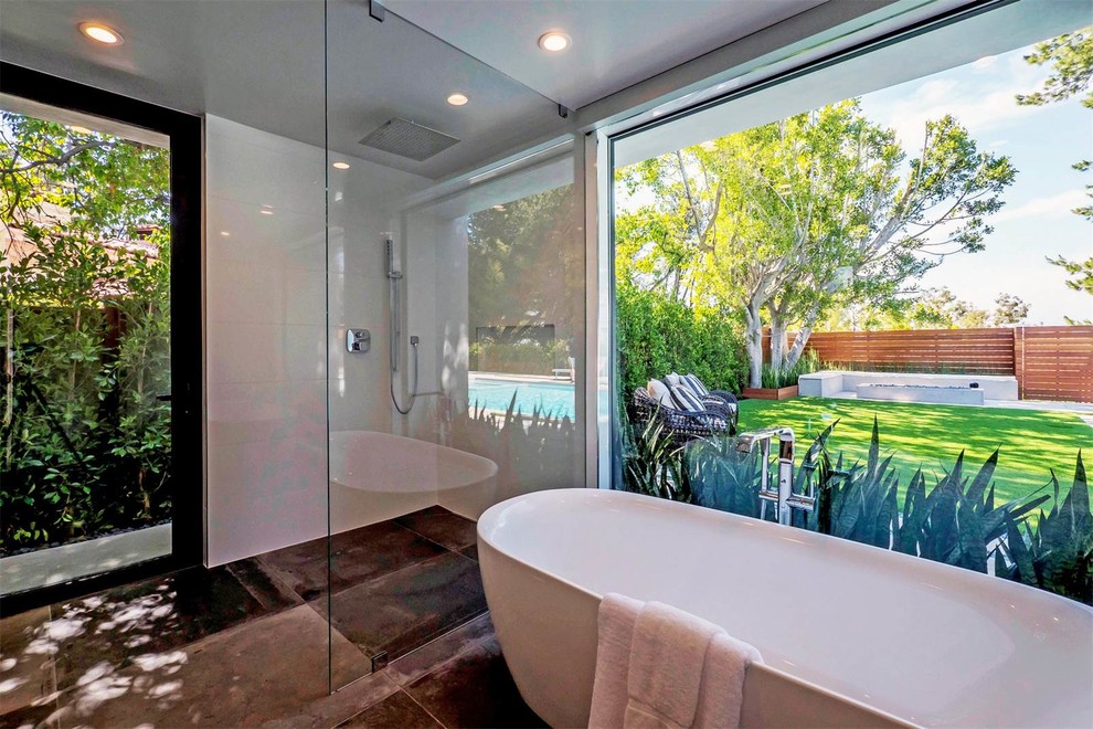 Bathroom - mid-sized contemporary master concrete floor and gray floor bathroom idea in Los Angeles with flat-panel cabinets, white cabinets, a one-piece toilet, white walls, an integrated sink and solid surface countertops