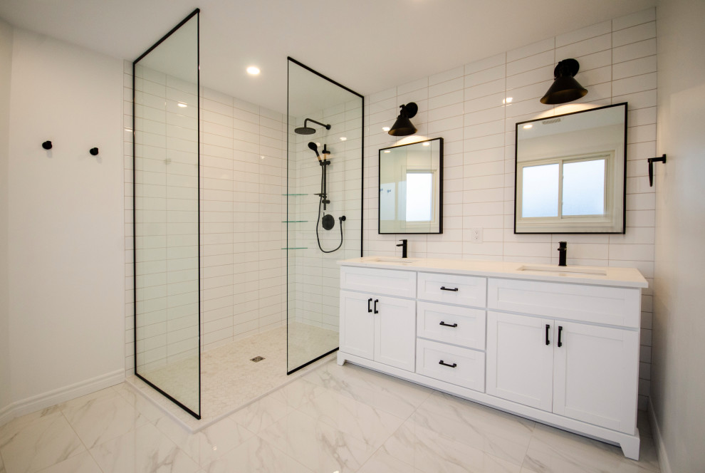 This is an example of a medium sized modern ensuite bathroom in Toronto with white cabinets, a walk-in shower, white tiles, porcelain tiles, engineered stone worktops, white worktops, double sinks and a freestanding vanity unit.
