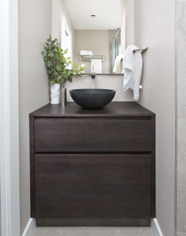 Bathroom - mid-sized contemporary bathroom idea in Detroit with flat-panel cabinets, brown cabinets, solid surface countertops and white walls