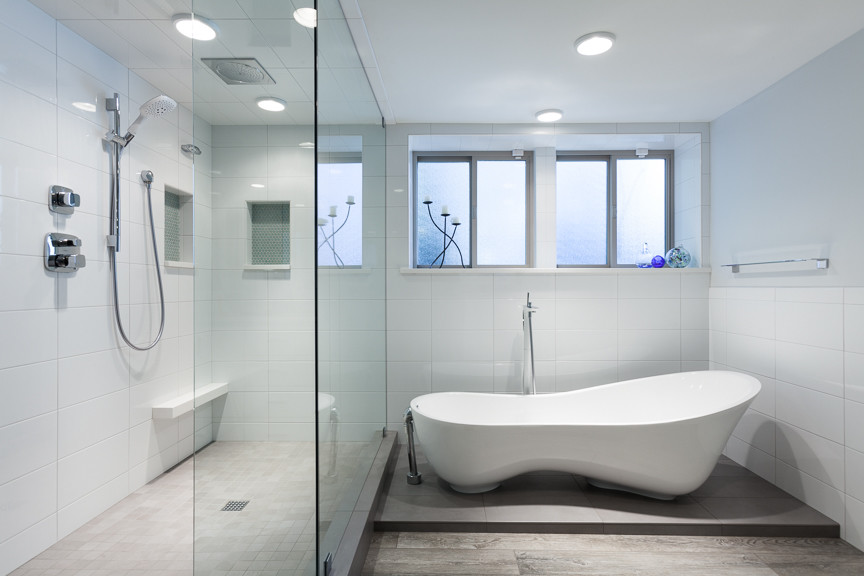 Mid-sized minimalist master white tile and ceramic tile ceramic tile bathroom photo in Portland with an undermount sink, flat-panel cabinets, white cabinets, quartz countertops, a one-piece toilet and blue walls