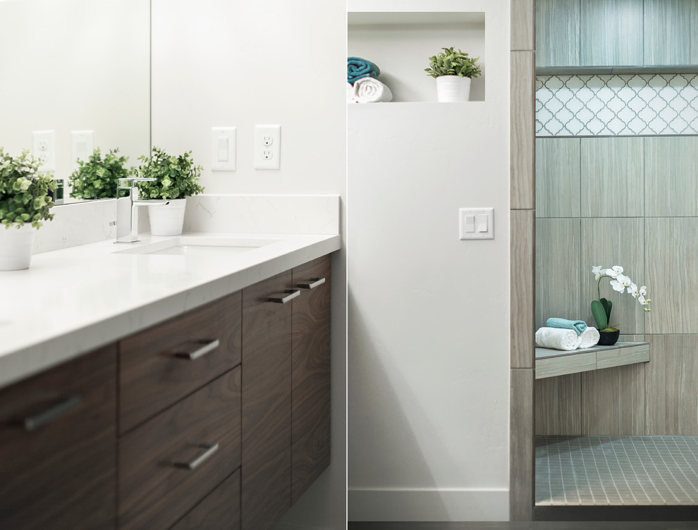 Inspiration pour une grande douche en alcôve principale minimaliste en bois brun avec un placard à porte plane, un carrelage gris, des carreaux de céramique, un mur blanc, un lavabo encastré et un plan de toilette en quartz modifié.