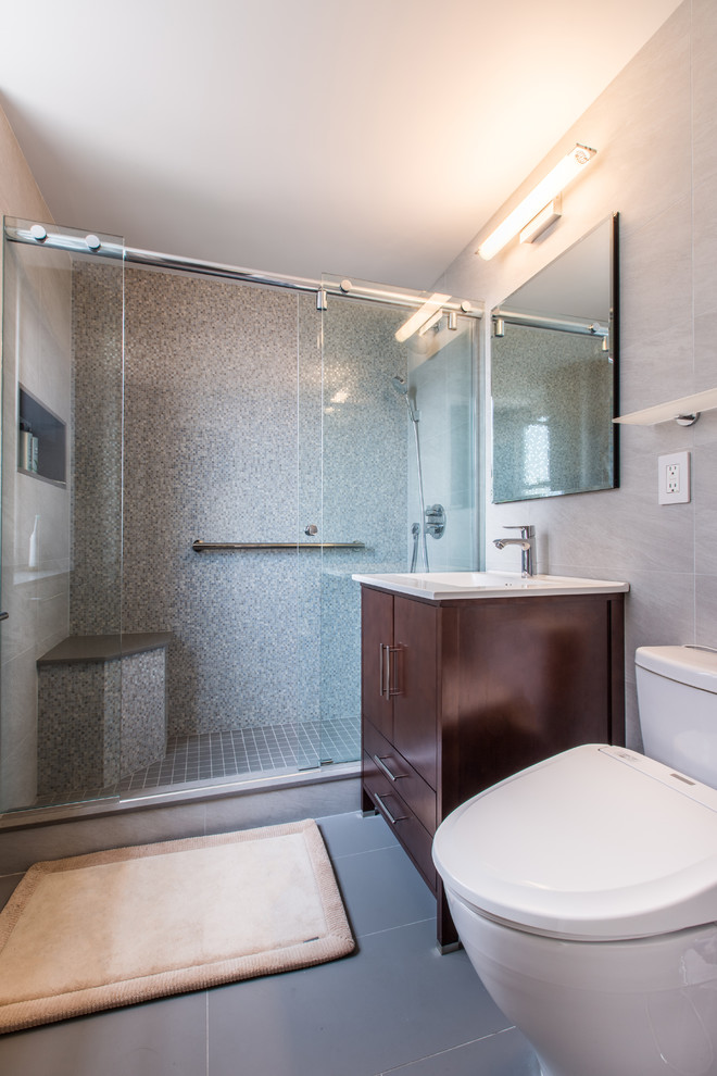 Mid-sized minimalist 3/4 gray tile, multicolored tile, white tile and mosaic tile linoleum floor alcove shower photo in New York with flat-panel cabinets, dark wood cabinets, a two-piece toilet, gray walls, an undermount sink and quartz countertops