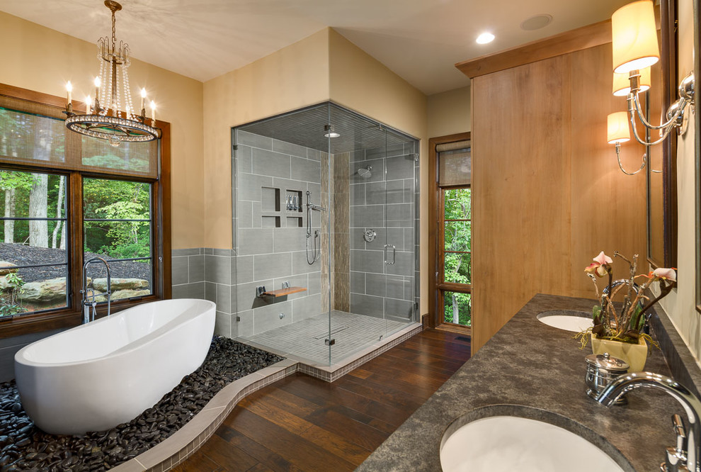 Inspiration for a transitional master gray tile and ceramic tile dark wood floor bathroom remodel in Other with shaker cabinets, medium tone wood cabinets, a two-piece toilet, yellow walls, an undermount sink, granite countertops and a hinged shower door