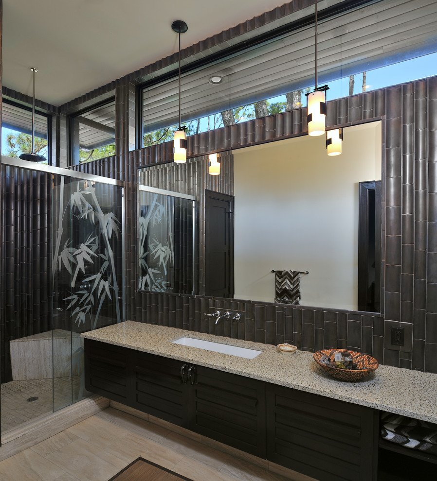 Modelo de cuarto de baño actual con lavabo de seno grande, puertas de armario de madera en tonos medios, ducha empotrada y baldosas y/o azulejos beige