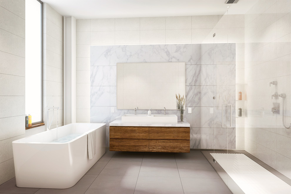 Exemple d'une salle de bain principale tendance en bois brun de taille moyenne avec un placard à porte plane, une baignoire indépendante, une douche à l'italienne, un carrelage blanc, un carrelage de pierre, un mur blanc, une vasque, un plan de toilette en marbre, WC séparés et un sol en carrelage de porcelaine.