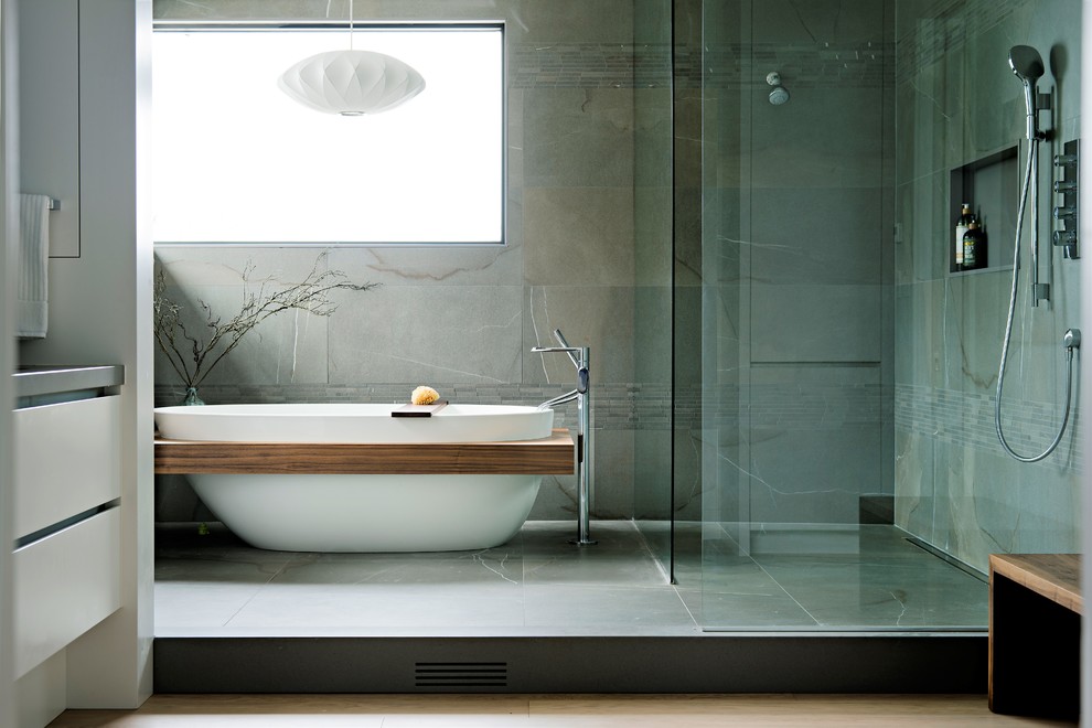 Inspiration för ett mycket stort funkis grå grått en-suite badrum, med släta luckor, vita skåp, ett fristående badkar, en kantlös dusch, grå kakel, porslinskakel, klinkergolv i porslin, bänkskiva i kvarts, med dusch som är öppen och grått golv