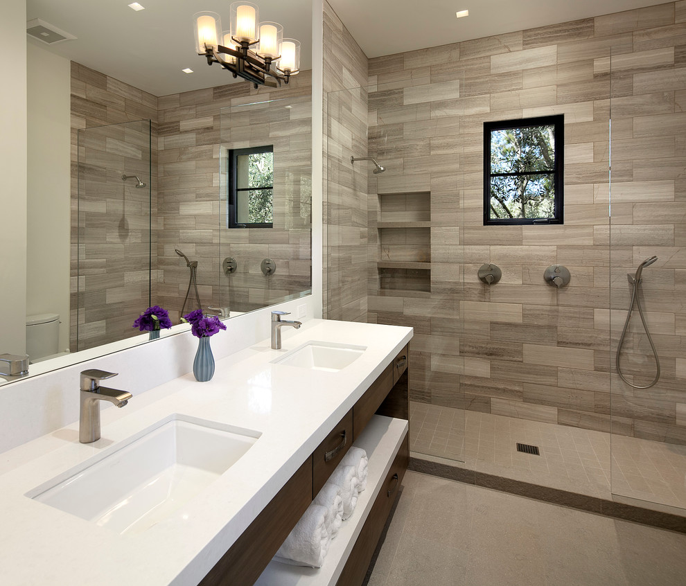 Example of a large tuscan master gray tile and stone tile porcelain tile alcove shower design in Santa Barbara with an undermount sink, flat-panel cabinets, dark wood cabinets, white walls and solid surface countertops