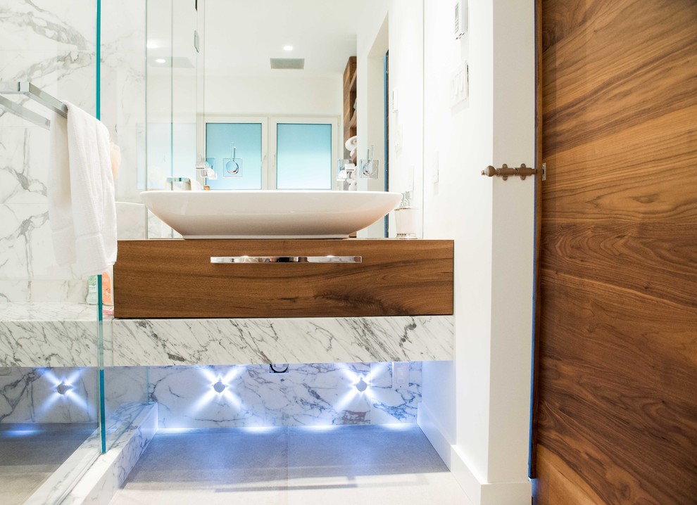 Double shower - mid-sized contemporary master white tile and stone tile ceramic tile double shower idea in Vancouver with a vessel sink, flat-panel cabinets, medium tone wood cabinets, marble countertops, a one-piece toilet and white walls