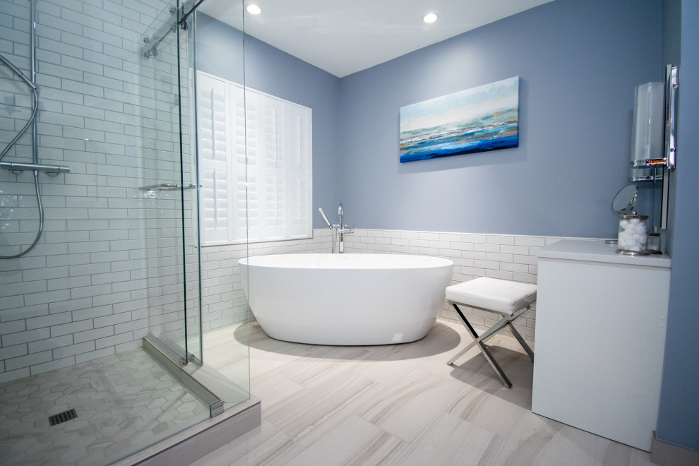 Bathroom - large modern master white tile and subway tile beige floor and ceramic tile bathroom idea in Seattle with raised-panel cabinets, white cabinets, a two-piece toilet, blue walls, an undermount sink, quartzite countertops and white countertops