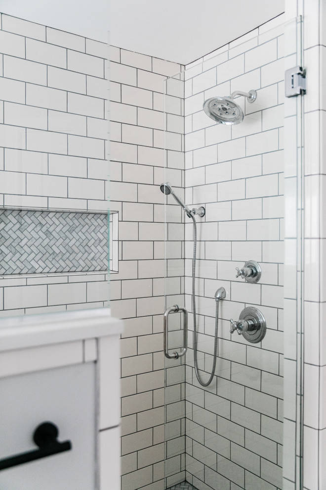 Mid-sized minimalist master white tile and subway tile ceramic tile and black floor bathroom photo in Other with raised-panel cabinets, medium tone wood cabinets, a one-piece toilet, gray walls, an undermount sink, quartz countertops, a hinged shower door and white countertops