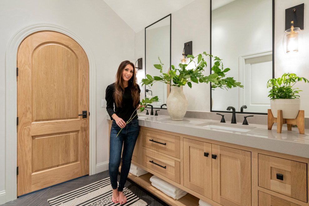 Example of a large minimalist master gray floor, double-sink and vaulted ceiling bathroom design in Minneapolis with light wood cabinets, beige walls, a trough sink, a hinged shower door, beige countertops and a built-in vanity