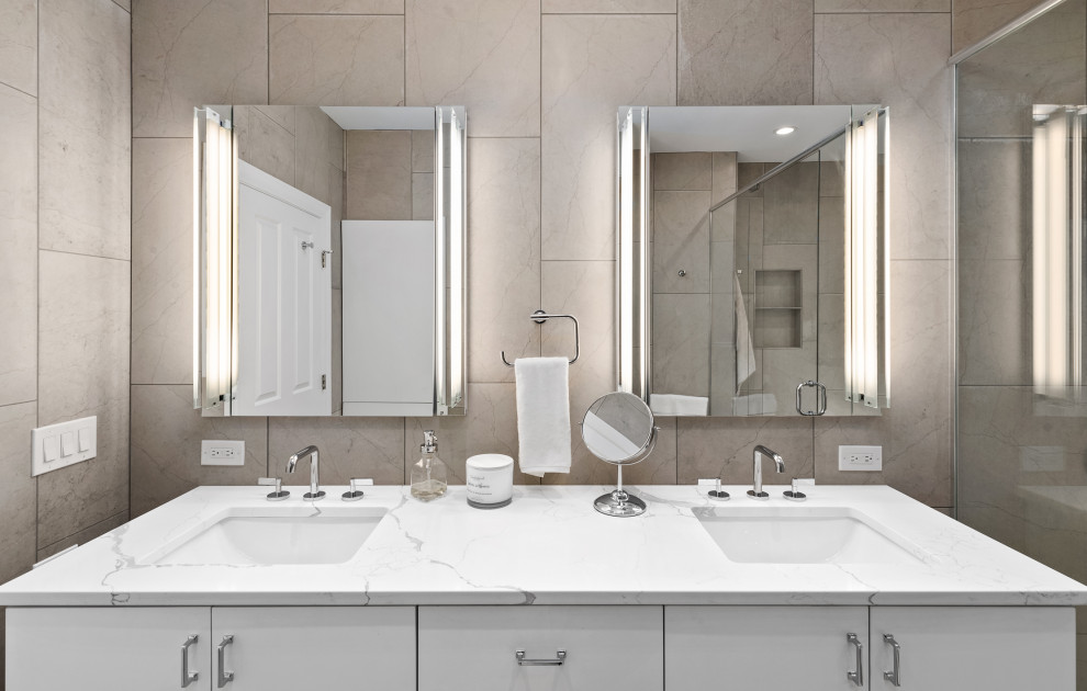 This is an example of a large modern ensuite wet room bathroom with flat-panel cabinets, white cabinets, a built-in bath, a two-piece toilet, grey tiles, marble tiles, grey walls, marble flooring, a submerged sink, engineered stone worktops, grey floors, a hinged door, white worktops, a wall niche, double sinks and a freestanding vanity unit.