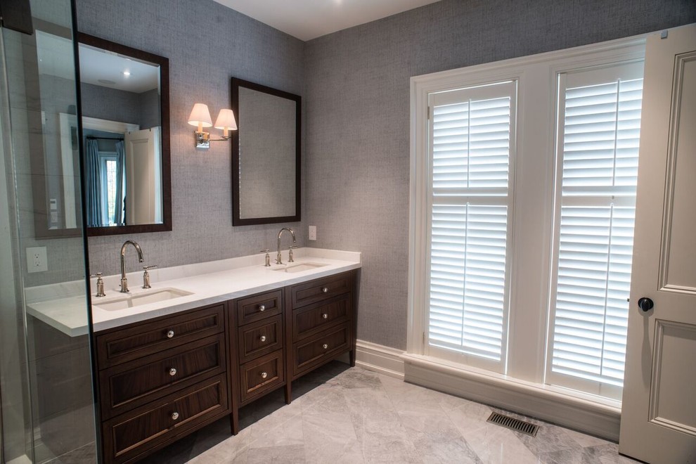Medium sized modern ensuite bathroom in Toronto with shaker cabinets, dark wood cabinets, a freestanding bath, a walk-in shower, a one-piece toilet, grey tiles, white tiles, stone tiles, grey walls, marble flooring, a submerged sink and marble worktops.